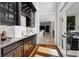 Convenient wet bar with granite countertop, wine rack, custom cabinets and outdoor access at 948 Saint Lyonn Cts, Marietta, GA 30068