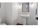 Bathroom with pedestal sink, modern faucet, and beadboard wainscoting at 948 Saint Lyonn Cts, Marietta, GA 30068