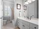 Bright bathroom featuring a white vanity with drawers and a shower tub combination at 948 Saint Lyonn Cts, Marietta, GA 30068
