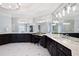 Lavish primary bathroom featuring dual marble vanities, mirrored walls, and an elegant chandelier creating a serene atmosphere at 948 Saint Lyonn Cts, Marietta, GA 30068