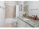 Bathroom with granite countertop, white vanity and tile shower at 948 Saint Lyonn Cts, Marietta, GA 30068