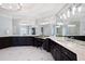 Spacious bathroom with dual sinks, dark cabinetry, marble countertops, statement mirrors and unique lighting at 948 Saint Lyonn Cts, Marietta, GA 30068