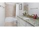 Bathroom featuring granite counters, a tub with shower, and tile flooring at 948 Saint Lyonn Cts, Marietta, GA 30068