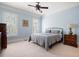 Bright and airy bedroom with a comfortable bed, carpeted floor, and light blue walls and trim at 948 Saint Lyonn Cts, Marietta, GA 30068