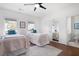 Bright bedroom featuring two twin beds, hardwood floors, and a bathroom suite at 948 Saint Lyonn Cts, Marietta, GA 30068