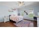 Comfortable bedroom with light blue walls, hardwood floors, and natural light at 948 Saint Lyonn Cts, Marietta, GA 30068