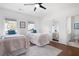 Bright bedroom features hardwood floors, two beds, and access to an en-suite bathroom at 948 Saint Lyonn Cts, Marietta, GA 30068