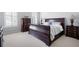 A spacious bedroom with a large wood bed and natural light from the windows at 948 Saint Lyonn Cts, Marietta, GA 30068