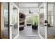 View from inside showing the covered porch with stone fireplace, ceiling fan, and ample seating at 948 Saint Lyonn Cts, Marietta, GA 30068