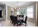 Bright formal dining room with elegant chandelier and light filtering window shades at 948 Saint Lyonn Cts, Marietta, GA 30068