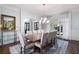 Formal dining room with modern chandelier, decorative molding, and expansive windows at 948 Saint Lyonn Cts, Marietta, GA 30068