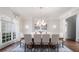 Bright dining room with hardwood floors, decorative chandelier, large windows and seating for ten at 948 Saint Lyonn Cts, Marietta, GA 30068