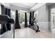 Bright exercise room with treadmill, elliptical machine, and large windows at 948 Saint Lyonn Cts, Marietta, GA 30068