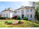 Elegant white brick home boasts meticulous landscaping, a manicured lawn, and a classic design at 948 Saint Lyonn Cts, Marietta, GA 30068