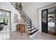 Spacious foyer with hardwood stairs, iron railing, tile floor and transom window at 948 Saint Lyonn Cts, Marietta, GA 30068