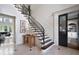 Elegant foyer showcasing a staircase with wrought iron railing and stylish decor at 948 Saint Lyonn Cts, Marietta, GA 30068
