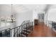 A grand staircase leads down to the foyer with a chandelier and large window with views at 948 Saint Lyonn Cts, Marietta, GA 30068