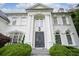 Charming home entrance with a beautiful set of paneled double doors and manicured landscaping at 948 Saint Lyonn Cts, Marietta, GA 30068