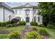 Elegant white home with manicured landscaping, mature trees, and a charming front yard at 948 Saint Lyonn Cts, Marietta, GA 30068