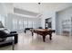 Game room featuring pool table, foosball table, wet bar and ample natural light, perfect for entertaining at 948 Saint Lyonn Cts, Marietta, GA 30068