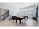 Spacious game room with a pool table, foosball, staircase, and multiple windows for lots of natural light at 948 Saint Lyonn Cts, Marietta, GA 30068