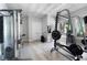 Well-equipped gym with various weight machines and view to backyard at 948 Saint Lyonn Cts, Marietta, GA 30068