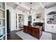 Well-appointed home office with custom built-ins, a fireplace, coffered ceilings, and ample natural light at 948 Saint Lyonn Cts, Marietta, GA 30068