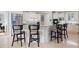 Modern kitchen featuring an island with seating, stone countertops, stainless steel appliances, and bright lighting at 948 Saint Lyonn Cts, Marietta, GA 30068