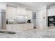 Bright kitchen featuring white cabinets, granite countertops, stainless steel appliances, and a stylish subway tile backsplash at 948 Saint Lyonn Cts, Marietta, GA 30068