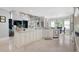 Spacious open-concept kitchen with custom cabinets, and stone countertops connected to living area at 948 Saint Lyonn Cts, Marietta, GA 30068