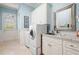 Bright laundry room features modern washer and dryer, sink, and ample cabinet space at 948 Saint Lyonn Cts, Marietta, GA 30068