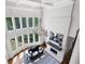 Bright living room with large windows, fireplace, hardwood floors, and elegant chandelier at 948 Saint Lyonn Cts, Marietta, GA 30068