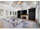 Bright living room featuring a stone fireplace, custom built-ins, and large windows with beautiful outdoor views at 948 Saint Lyonn Cts, Marietta, GA 30068