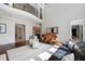Bright and open living room featuring a piano, high ceilings, and an elegant wrought iron balcony at 948 Saint Lyonn Cts, Marietta, GA 30068