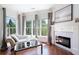Cozy living room with a fireplace, hardwood floors, a couch and lots of windows at 948 Saint Lyonn Cts, Marietta, GA 30068