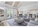 Open living room with fireplace, access to the outdoor porch, and adjacent kitchen at 948 Saint Lyonn Cts, Marietta, GA 30068
