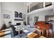 Open-concept living space with fireplace, piano, balcony view, and ample natural light at 948 Saint Lyonn Cts, Marietta, GA 30068