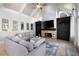 Vaulted ceiling in living room with stone fireplace, tv, and grey sectional seating at 948 Saint Lyonn Cts, Marietta, GA 30068