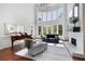Bright living room features hardwood floors, a fireplace, a baby grand piano, and soaring windows at 948 Saint Lyonn Cts, Marietta, GA 30068