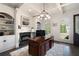 Sophisticated office space featuring custom built-ins, a fireplace, and a stately executive desk at 948 Saint Lyonn Cts, Marietta, GA 30068