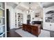 Well-appointed office with custom built-ins, a fireplace, and a large wooden desk at 948 Saint Lyonn Cts, Marietta, GA 30068