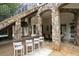 Outdoor bar area with stone columns, a bar counter, and seating, perfect for entertaining by the pool at 948 Saint Lyonn Cts, Marietta, GA 30068
