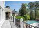 Large outdoor deck overlooking a pool, with fireplace and TV area at 948 Saint Lyonn Cts, Marietta, GA 30068