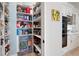 Well-organized pantry with ample shelving, next to gourmet kitchen with granite counters at 948 Saint Lyonn Cts, Marietta, GA 30068