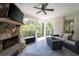 Relaxing covered patio with stone fireplace and comfortable seating, perfect for outdoor entertaining at 948 Saint Lyonn Cts, Marietta, GA 30068
