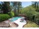 Lounge by the pool with stone deck with a beautiful wooded view, perfect for relaxation and entertainment at 948 Saint Lyonn Cts, Marietta, GA 30068