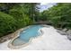 Beautiful backyard pool with waterfall features, stone accents, and comfortable lounging areas at 948 Saint Lyonn Cts, Marietta, GA 30068