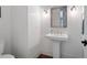 Powder room features wood floors, sink, and mirror at 948 Saint Lyonn Cts, Marietta, GA 30068
