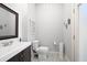 Cozy powder room featuring a dark wood vanity, a white countertop sink, and decorative wall art at 948 Saint Lyonn Cts, Marietta, GA 30068