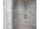 Bathroom shower with marble tile, a built-in seat, and stylish glass door in this luxury property at 948 Saint Lyonn Cts, Marietta, GA 30068